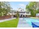 Inviting backyard showcases a pool, lawn, lush trees, and the home's exterior at 3109 Country Lake Dr, Powder Springs, GA 30127