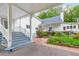 Beautiful backyard with a fountain feature, colorful flowers, brick patio, and blue-painted steps to the home's entrance at 3109 Country Lake Dr, Powder Springs, GA 30127