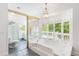 Sunlit bathroom with a large soaking tub, shower, and large windows with tree views at 3109 Country Lake Dr, Powder Springs, GA 30127