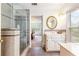 Bathroom featuring tiled walk-in shower, white vanity, and large window at 3109 Country Lake Dr, Powder Springs, GA 30127