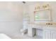All-white bathroom featuring vintage vanity, white beadboard paneling, and tiled floor at 3109 Country Lake Dr, Powder Springs, GA 30127