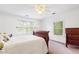 Bright bedroom featuring two large windows, a sleigh bed, and a dark wood dresser at 3109 Country Lake Dr, Powder Springs, GA 30127