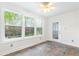 Bright bonus room with tile floors, large windows offering natural light and outdoor views, and a door to a deck at 3109 Country Lake Dr, Powder Springs, GA 30127