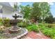Charming backyard fountain surrounded by lush landscaping and brick pathways at 3109 Country Lake Dr, Powder Springs, GA 30127