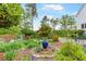 Lush front yard with a variety of plants and flowers, leading to the charming home at 3109 Country Lake Dr, Powder Springs, GA 30127