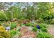 Beautifully landscaped gardens with brick pathways and a variety of plants and flowers at 3109 Country Lake Dr, Powder Springs, GA 30127