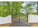 Private gated entrance and driveway surrounded by mature trees at 3109 Country Lake Dr, Powder Springs, GA 30127