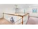 Upstairs hallway with white railing, elegant light fixture, and stained glass window feature at 3109 Country Lake Dr, Powder Springs, GA 30127
