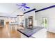 Open kitchen featuring an island with countertop seating, white cabinets and a hardwood floor at 3109 Country Lake Dr, Powder Springs, GA 30127