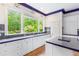 Bright kitchen with custom cabinetry, granite countertops, and a scenic backyard view at 3109 Country Lake Dr, Powder Springs, GA 30127