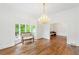 Bright living room boasting hardwood floors, a large window, and classic chandelier at 3109 Country Lake Dr, Powder Springs, GA 30127