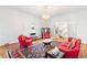 Bright living room with a decorative rug, fireplace, and access to staircase via french doors at 3109 Country Lake Dr, Powder Springs, GA 30127
