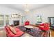 Elegant living room featuring a fireplace, chandelier lighting, and large windows for natural light at 3109 Country Lake Dr, Powder Springs, GA 30127
