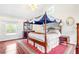 Main bedroom featuring a red carpet, a four-poster bed, and a view from a window at 3109 Country Lake Dr, Powder Springs, GA 30127