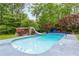 Inviting backyard features an in-ground pool with lush landscaping and a slide at 3109 Country Lake Dr, Powder Springs, GA 30127