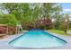 Backyard with in-ground pool, diving board and lush landscaping at 3109 Country Lake Dr, Powder Springs, GA 30127