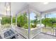Inviting porch with a swing and a scenic view of the lake and lush greenery at 3109 Country Lake Dr, Powder Springs, GA 30127