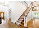 Grand foyer featuring an elegant staircase and hardwood floors leading to the upper level at 3109 Country Lake Dr, Powder Springs, GA 30127
