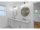 Bathroom with double vanity sinks, designer mirrors, and a glass shower at 90 Cleveland Unit B Se St, Atlanta, GA 30316