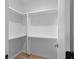 Bright walk-in closet with white shelving and hardwood flooring at 90 Cleveland Unit B Se St, Atlanta, GA 30316