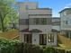 Exterior elevation featuring the rear of a modern home with clean lines, light siding, and private fencing at 90 Cleveland Unit B Se St, Atlanta, GA 30316