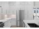 Well-appointed kitchen with stainless appliances, white cabinets, and stone backsplash at 90 Cleveland Unit B Se St, Atlanta, GA 30316