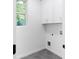 Well-lit laundry room with hexagon tile flooring and ample storage space at 90 Cleveland Unit B Se St, Atlanta, GA 30316