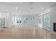 Open-concept living room featuring light hardwood floors, a modern fireplace, and large windows for abundant natural light at 90 Cleveland Unit B Se St, Atlanta, GA 30316