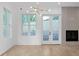 Well-lit living room with hardwood floors, a modern fireplace, large windows, and a contemporary chandelier at 90 Cleveland Unit B Se St, Atlanta, GA 30316