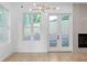 Spacious living room with modern lighting, a fireplace, and French doors at 90 Cleveland Unit B Se St, Atlanta, GA 30316
