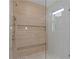 Detailed view of the shower with textured tile and bronze fixtures at 90 Cleveland Unit B Se St, Atlanta, GA 30316