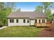 Exterior view showcasing a backyard with a well-maintained lawn and a charming wooden deck at 2279 Lakeview Pkwy, Villa Rica, GA 30180