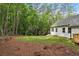 Spacious backyard with grass and a small deck, bordered by dense trees for privacy at 2279 Lakeview Pkwy, Villa Rica, GA 30180