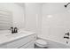 White bathroom featuring a tub/shower combo, toilet, and sink with black fixtures at 2279 Lakeview Pkwy, Villa Rica, GA 30180
