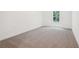 Cozy bedroom features soft carpeting and a window overlooking the yard at 2279 Lakeview Pkwy, Villa Rica, GA 30180