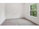 Bedroom with neutral carpet and a view of the surrounding forest outside of the window at 2279 Lakeview Pkwy, Villa Rica, GA 30180