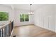 Well-lit dining room with board and batten wall paneling, hardwood floors and large windows for natural light at 2279 Lakeview Pkwy, Villa Rica, GA 30180