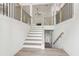 Bright foyer with stairs, wood floors, white walls, and an open view to the living room at 2279 Lakeview Pkwy, Villa Rica, GA 30180