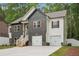 Home showcasing stone accents, white siding, dark accents and a two-car garage at 2279 Lakeview Pkwy, Villa Rica, GA 30180