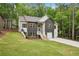 Front exterior featuring stone accents, white siding and a two-car garage at 2279 Lakeview Pkwy, Villa Rica, GA 30180