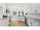 Modern kitchen with white cabinets, stainless steel appliances, granite countertops, and hardwood floors at 2279 Lakeview Pkwy, Villa Rica, GA 30180