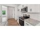 Modern kitchen with stainless steel appliances, granite countertops, herringbone backsplash and white cabinets at 2279 Lakeview Pkwy, Villa Rica, GA 30180