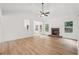 Bright living room with a fireplace, wood flooring, large windows, and a ceiling fan at 2279 Lakeview Pkwy, Villa Rica, GA 30180
