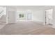 Bright open-concept living space with neutral carpet, white walls, and access to a bathroom at 2279 Lakeview Pkwy, Villa Rica, GA 30180