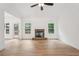 Bright living room with a stone fireplace, access to back porch, and expansive hardwood flooring at 2279 Lakeview Pkwy, Villa Rica, GA 30180