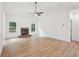 Living room with hardwood floors, a stone fireplace, and large windows providing plenty of natural light at 2279 Lakeview Pkwy, Villa Rica, GA 30180