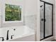 Main bathroom showcasing a bathtub and glass shower at 2279 Lakeview Pkwy, Villa Rica, GA 30180
