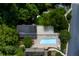 Overhead shot of the pool and amenity areas of the property bordered by mature trees and foliage at 301 Lakemoore Ne Dr # B, Atlanta, GA 30342