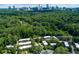An aerial view of the property with the city skyline in the background in a wooded area at 301 Lakemoore Ne Dr # B, Atlanta, GA 30342