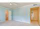 Light blue bedroom leading to a bathroom and walk-in closet with shelving at 301 Lakemoore Ne Dr # B, Atlanta, GA 30342